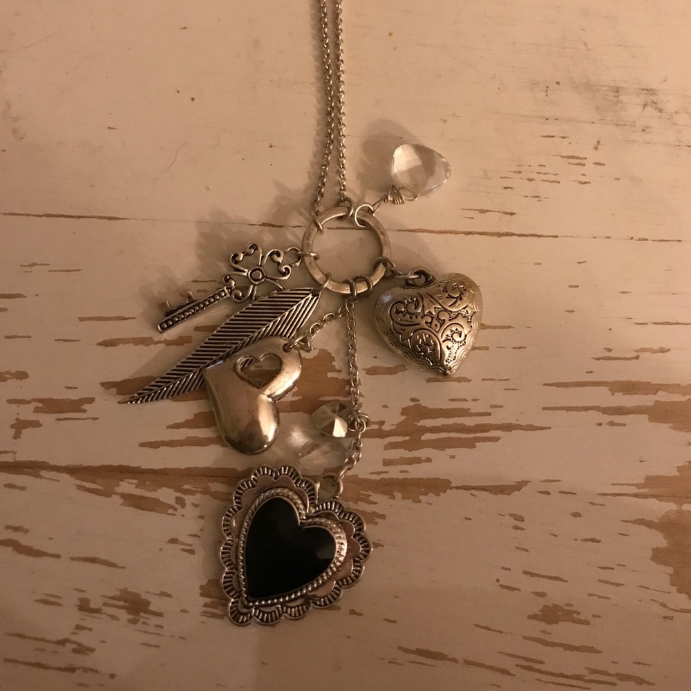 Long silver chain necklace with charms.